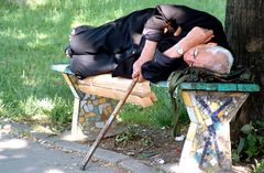 old man taking a nap on a bench...