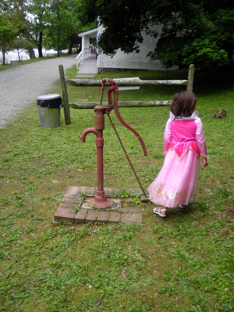 old water pump with Maya walking away