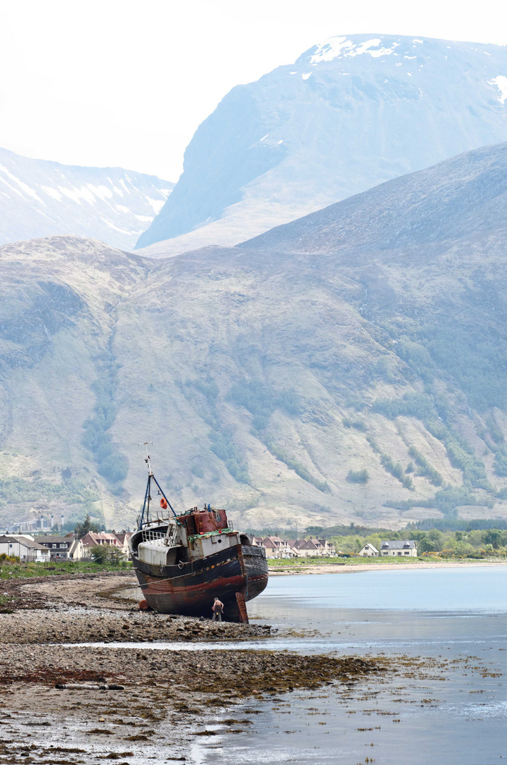 on the shore under the mountains