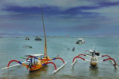 Outrigger boats on low tide in Sanur