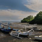 Outrigger boats stranded on low tide