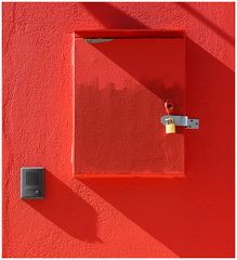 padlock on red wall