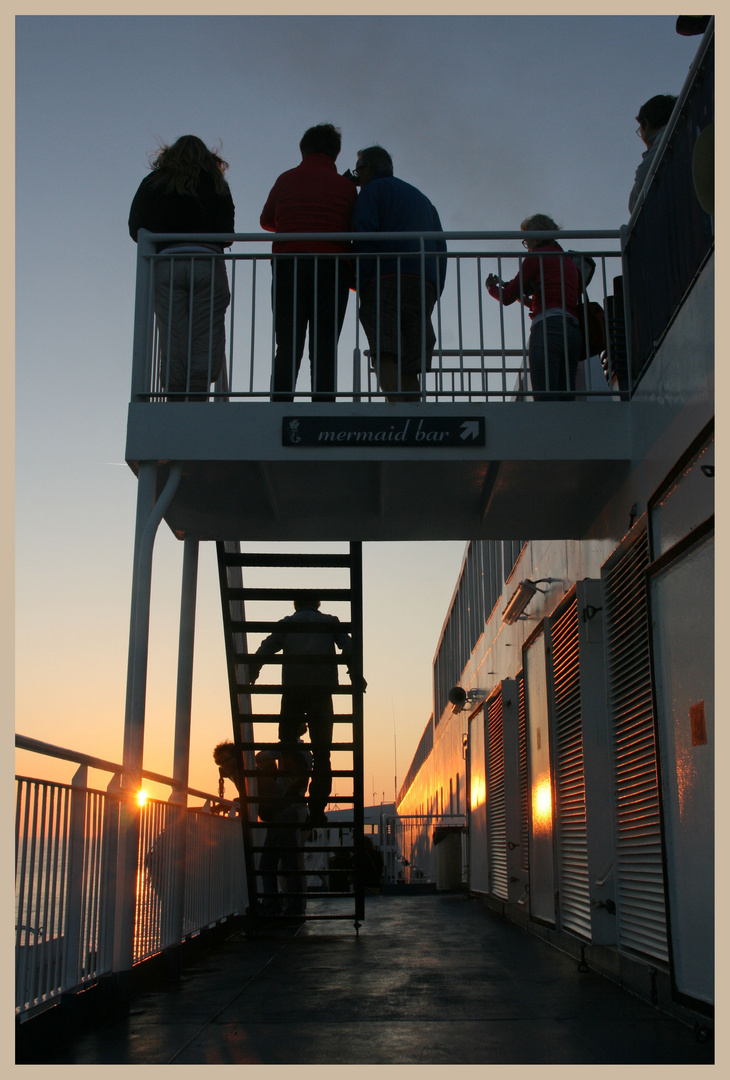 passengers watching the sunset from the DFDS ferry