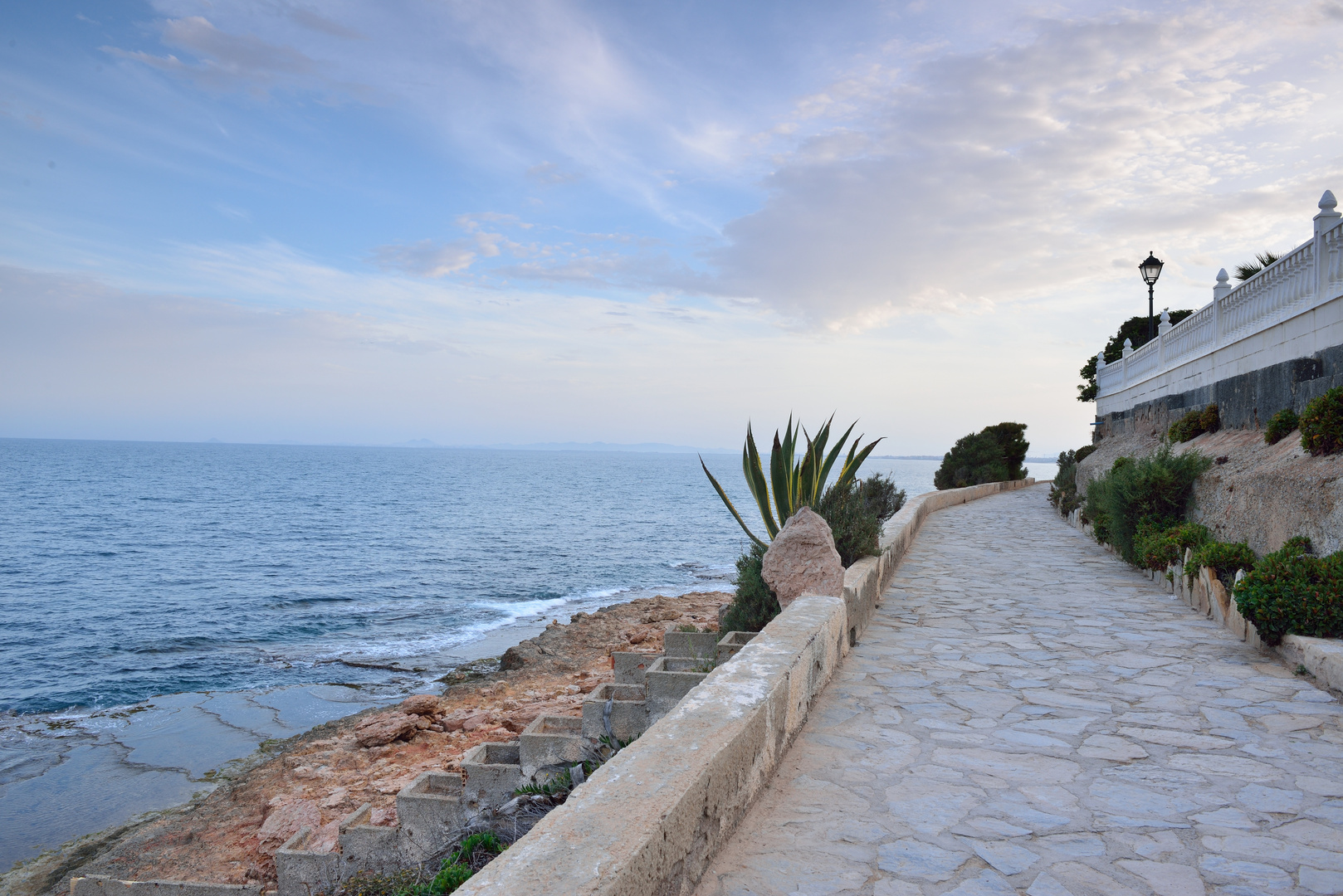 Paved coastal walkway on evening