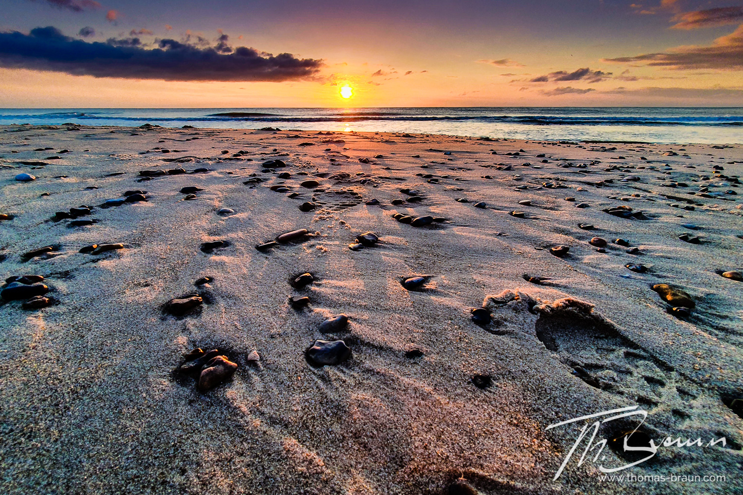 Pebbles, footprints and sand