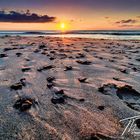 Pebbles, footprints and sand