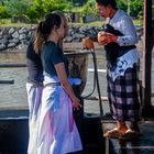 Pemangku priest spalshes holy water