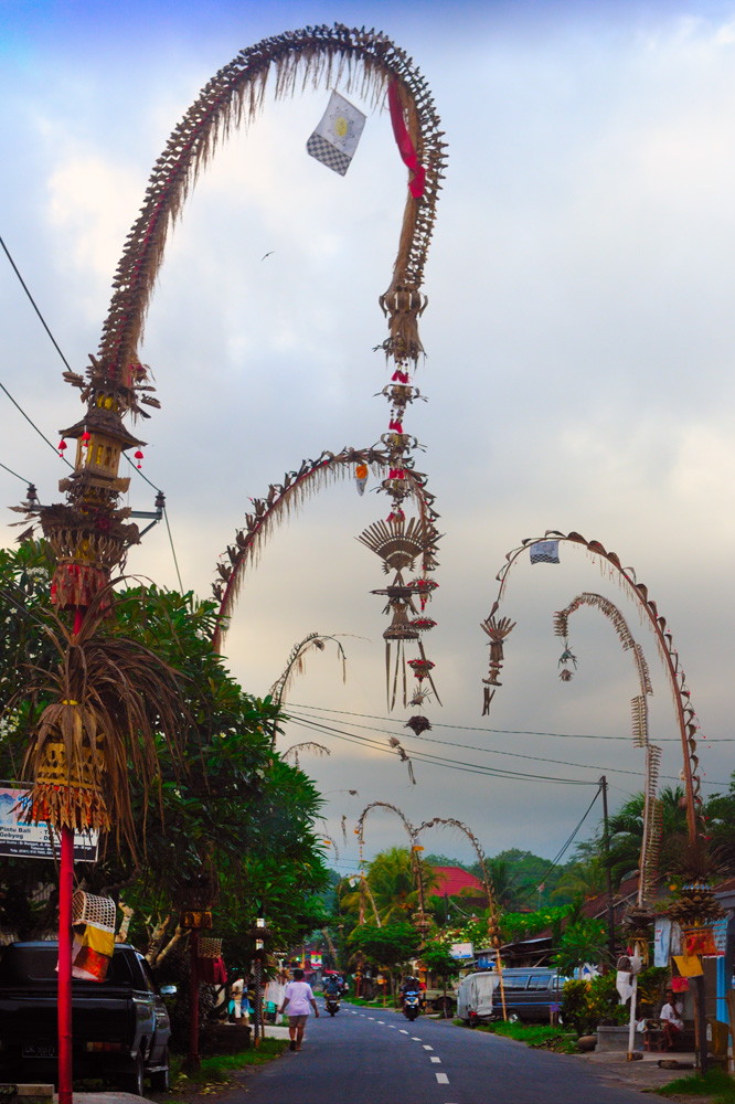 Penjor lining a road in Bali at Galungan