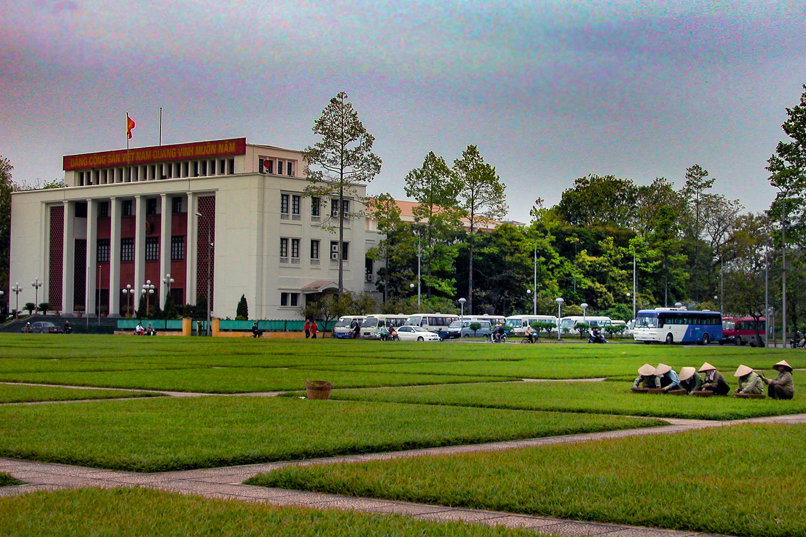 People cleaning an cutting the lawn grass