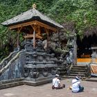 People pray in front of the cave