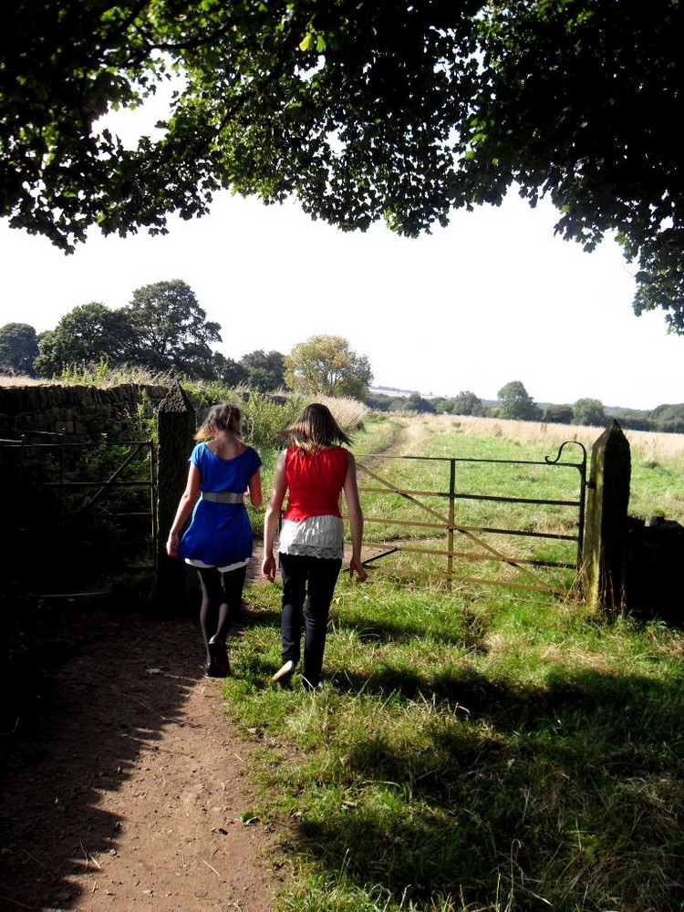 people walking towards a gate