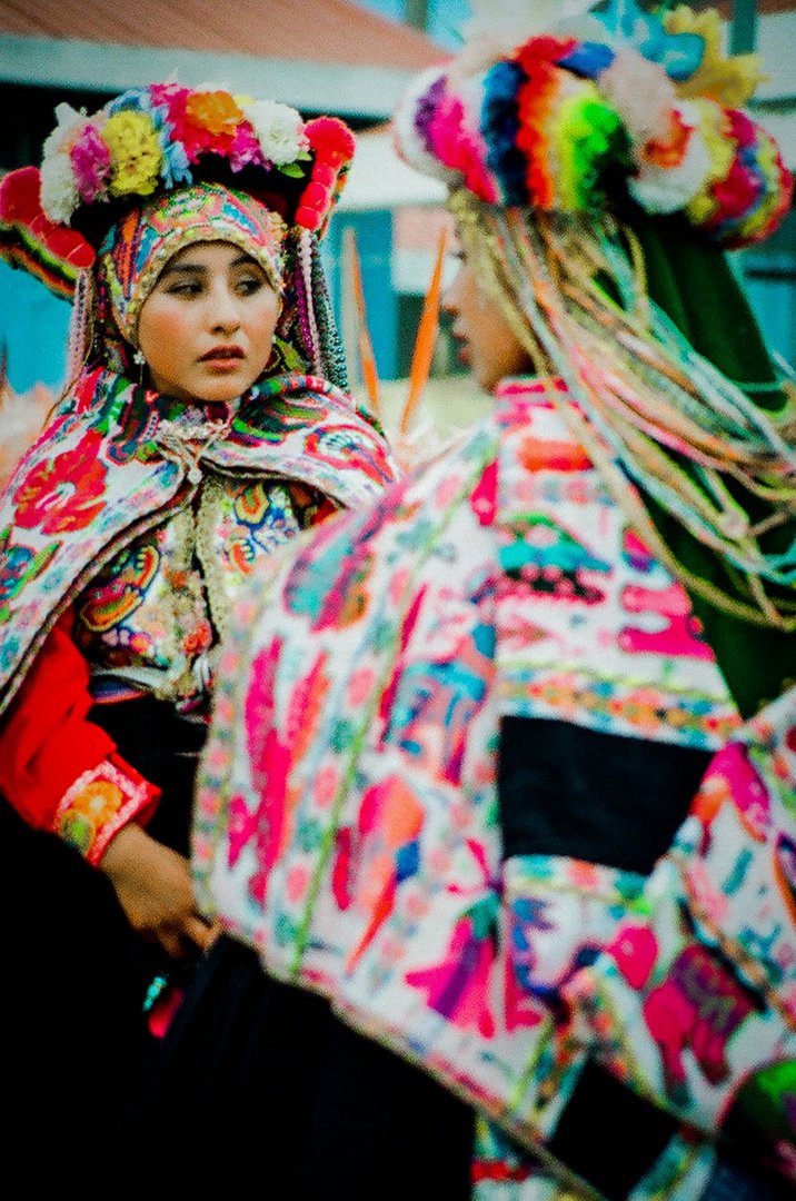 Peru | Women wearing a traditional costume during carnival festivities