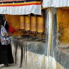 Pilgrim woman turning prayer wheels