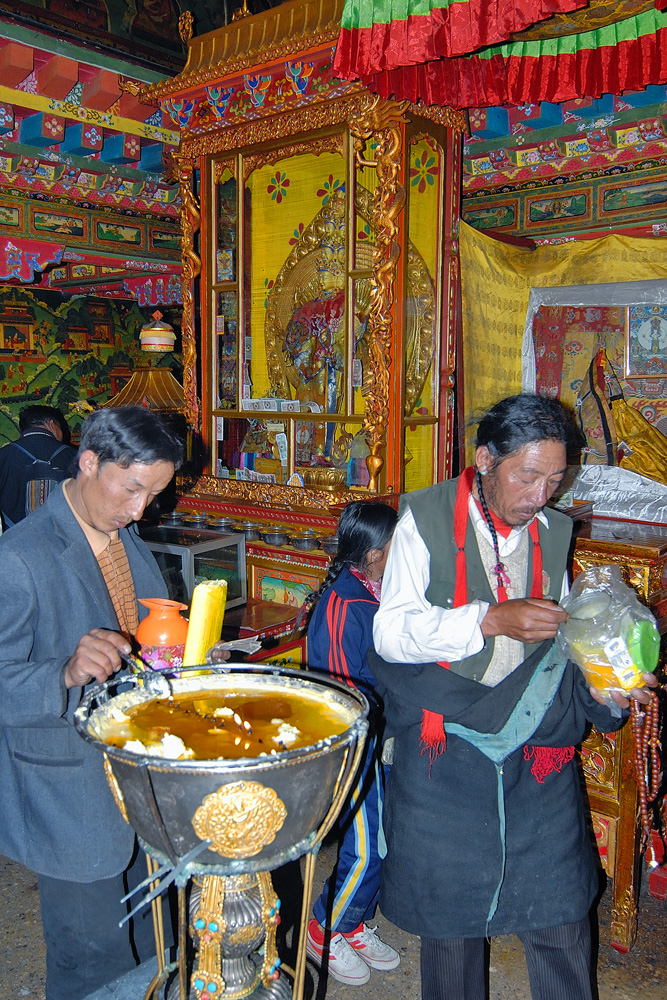 Pilgrims make a sacrifices with butter lambs and money bills