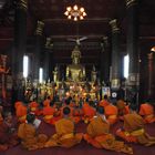 Praying in Wat Mai Souwannaphumaham