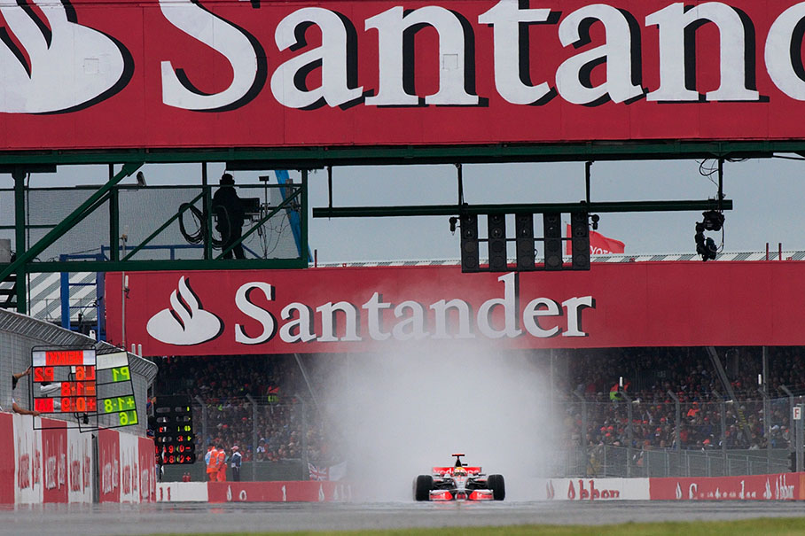 Race leader Hamilton on the long start & finish straight with a cloud of spray behind him