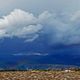 Rainbow under heavy rain clouds