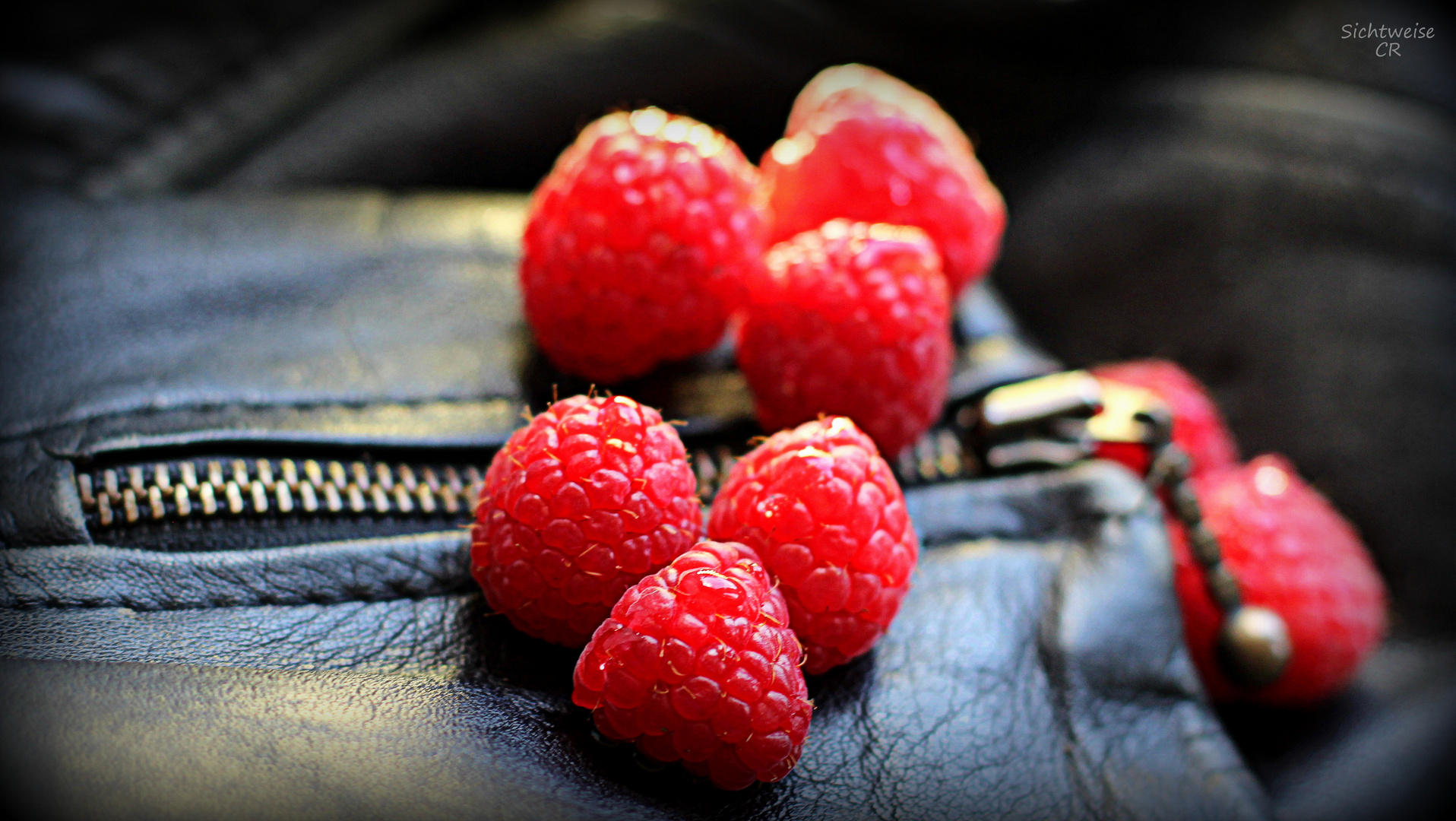 Raspberries on leather jacket