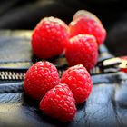 Raspberries on leather jacket