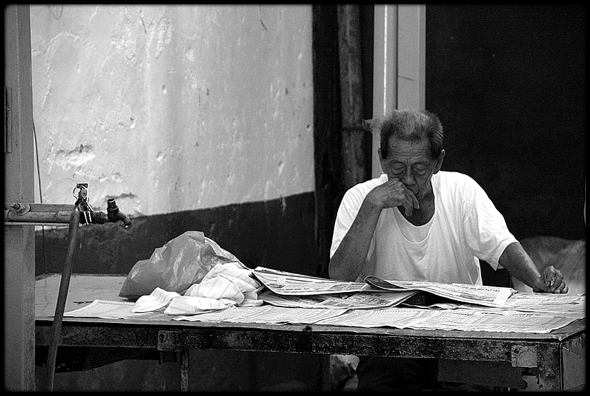 Reading the newspaper in Kuala Lumpur