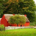 Red farmhouse in autumn