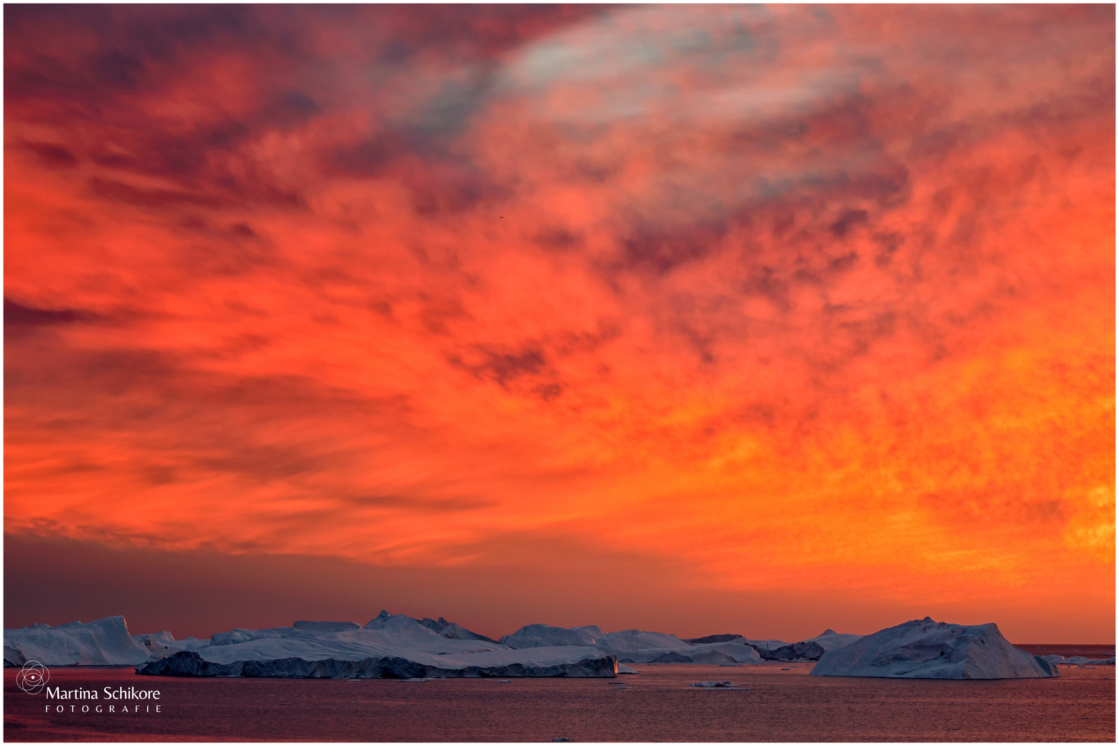 Red sky with icebergs in the Disco-Bay of Greenland