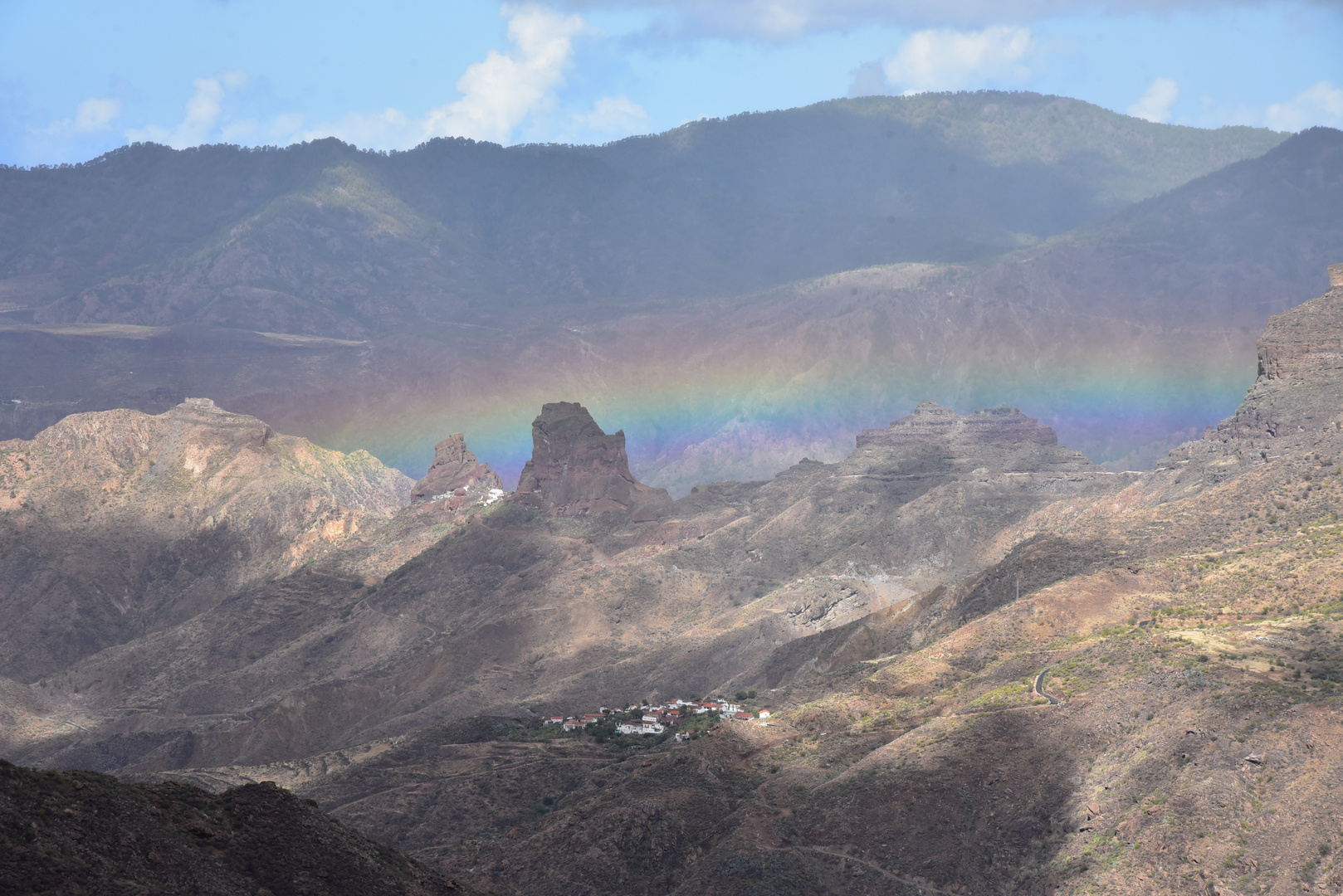 Regenbogen zwischen den Bergen