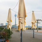 Rheinpromenade mit Rheinturm und Sonnenschirmen