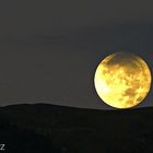 Rolling full moon on the mountain ridge...