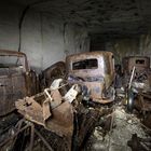 rusty cars in a cave