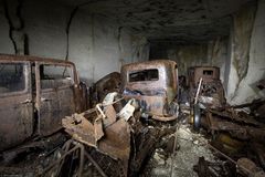 rusty cars in a cave