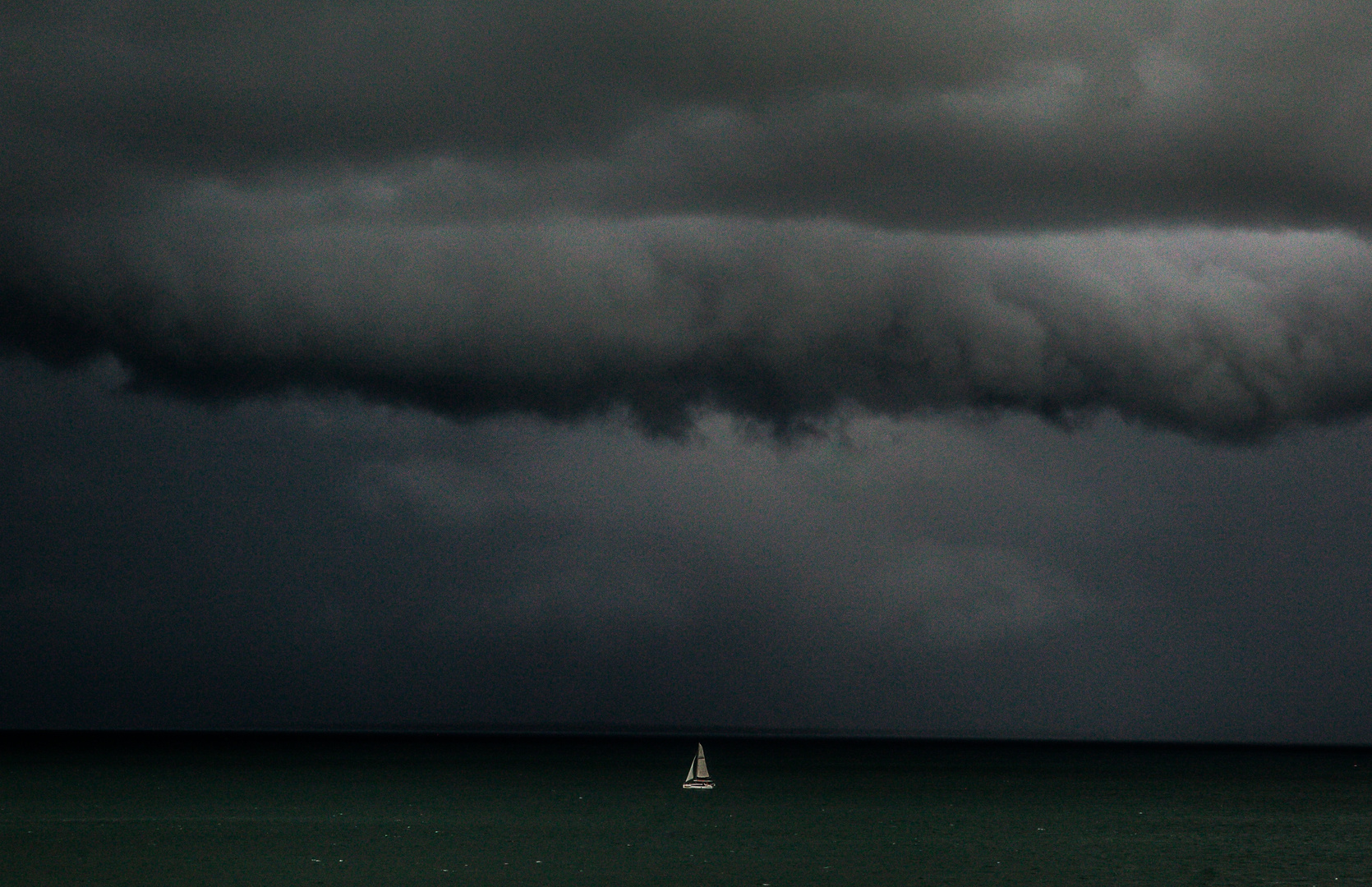 Sailing Boat And Upcoming Storm