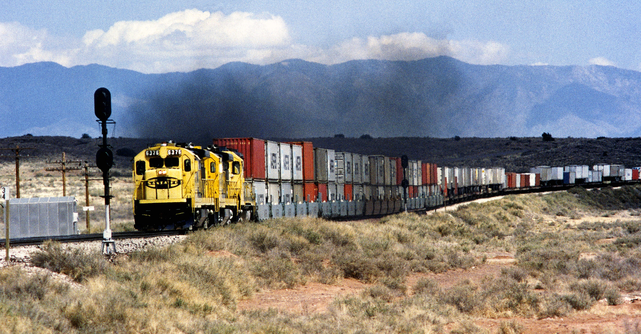 Santa Fe #6376 ATSF is leading a Double Stack Container and All purpose Cars withTrailer, Delies,NM