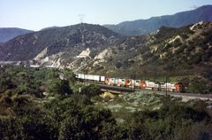 Santa Fe ATSF/BNSF red wb Locos are pulling a Trailer Train close to Rte.66,No.2,CA