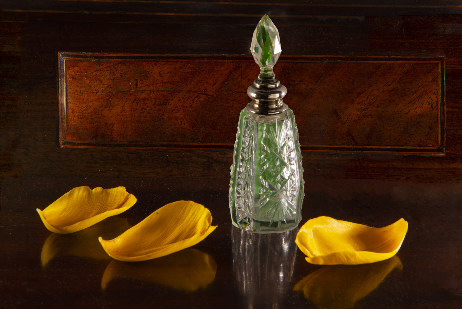 scent bottle and tulip petals 