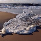 Schaummuster im Abendlicht am Strand von Sylt