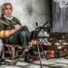Schuhmacher auf der Straße im China