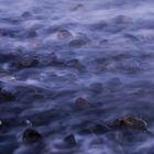 Sea mist over pebbles on the shore