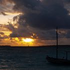 Segelboot mit Wolkenloch am Abend