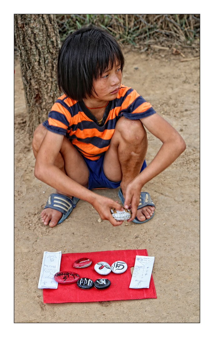 Selling her painted Stones on the side of the road