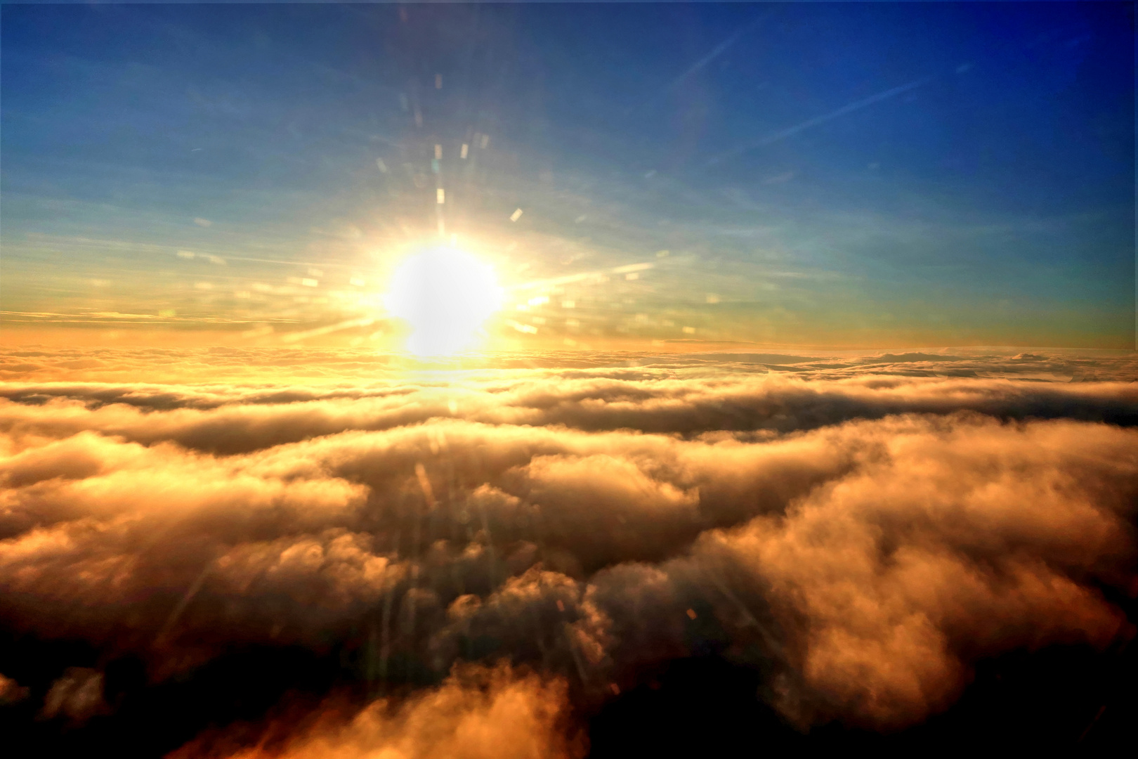 SETTING SUN ABOVE THE CLOUDS