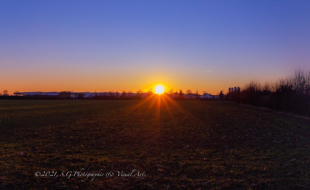 Setting sun beyond the solar park