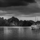 Ship under dark clouds in Ha Long Bay