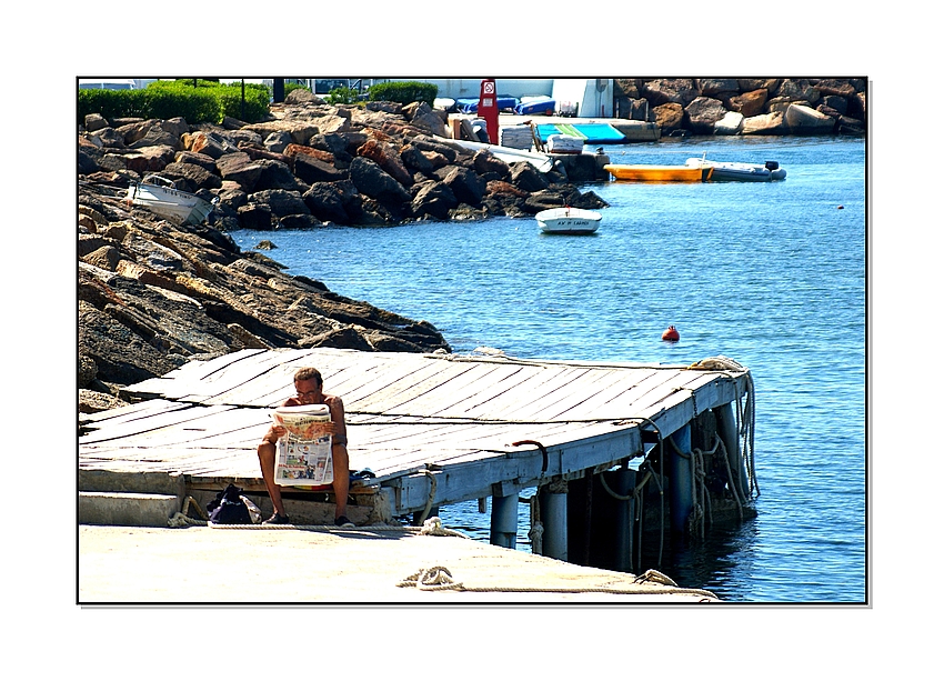 Sitting on a dock of a bay