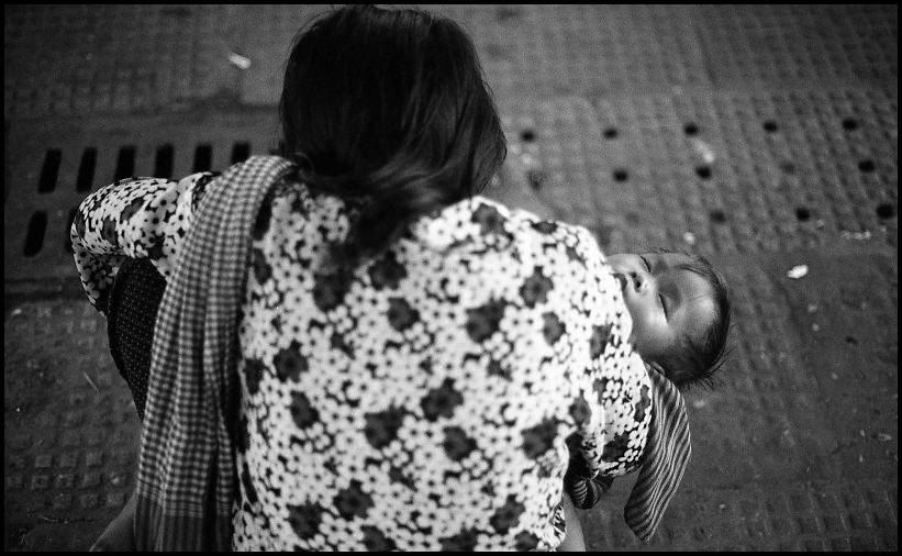 Sitting woman and sleeping child