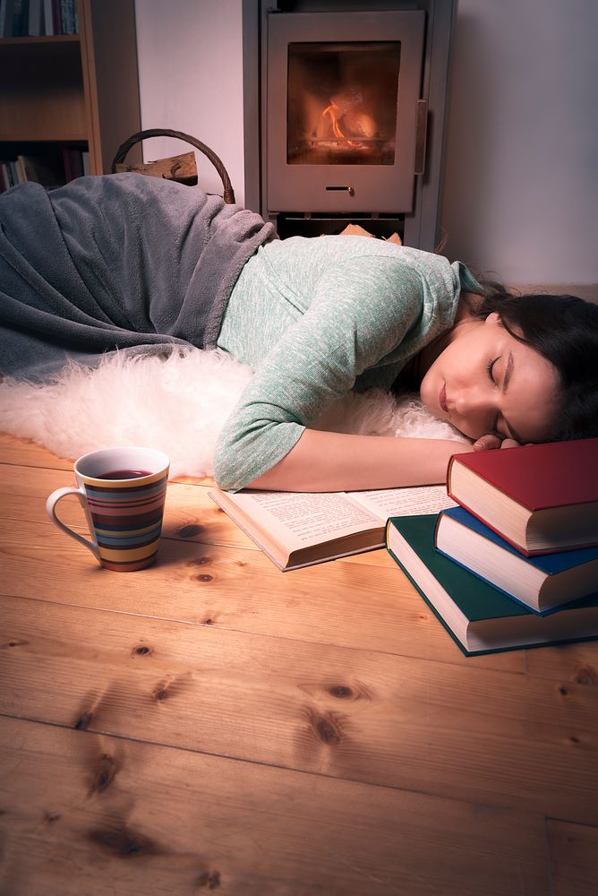 Sleeping girl surrounded by books