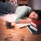 Sleeping girl surrounded by books