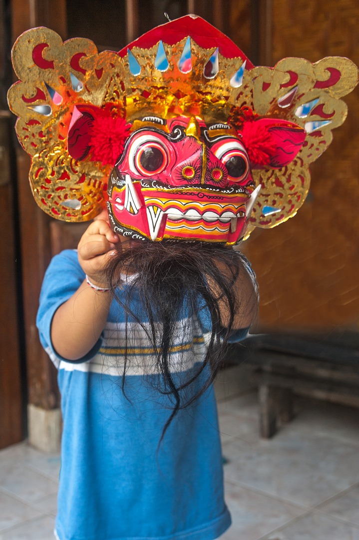 Small boy Aswin wearing Barong mask