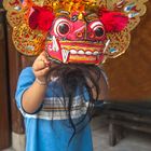 Small boy Aswin wearing Barong mask