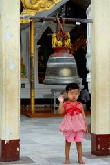 Small boy ringing small bell